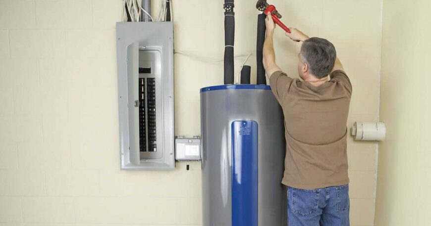 Plumber repairing home water heater system