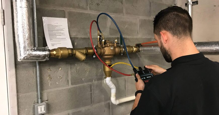 Plumber inspecting pipe using drain camera