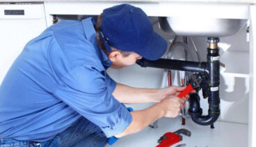 Professional plumber repairing underground water line