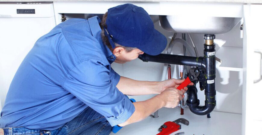 Professional plumber repairing underground water line