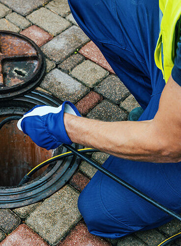 Plumber inspecting and repairing sewer line using camera