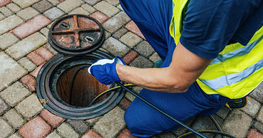 Plumber inspecting and repairing sewer line using camera